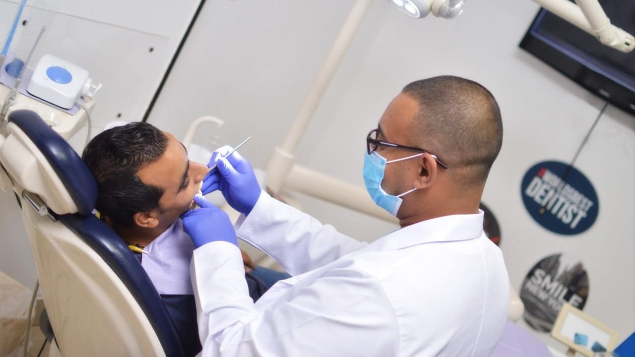 elite-smile-clinics-elgazaer-5 Dr. Ahmed Atteya performing procedure in operating room at Elite Smile Clinics Elgazaer branch - dental FAQs Cairo